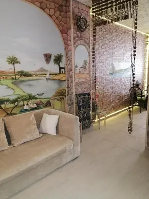 a living room with a couch and a mural at Apartment near the sea in Hurghada