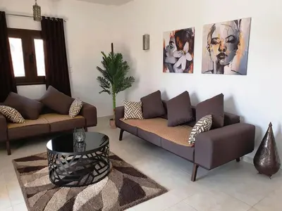 a living room with two couches and a table at CASA LOKO Guest House in Luxor