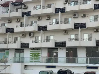 a building with cars parked in front of it at Studio in compaund in Hurghada