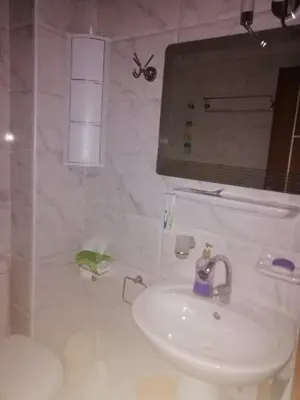 a white bathroom with a sink and a toilet at Studio in compaund in Hurghada