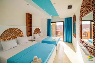 a hotel room with two beds and a balcony at All View Apartements Hurghada in Hurghada