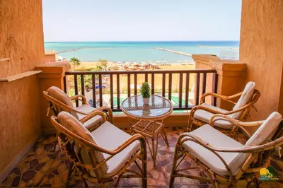 a balcony with a table and chairs and the ocean at All View Apartements Hurghada in Hurghada