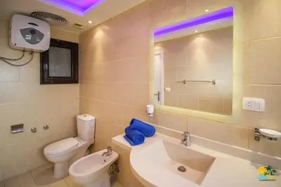 a bathroom with a white toilet and a sink and a tub at All View Apartements Hurghada in Hurghada