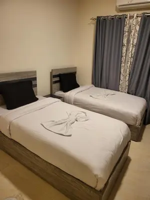 two twin beds in a room withskirts at Luxury Aqua Tropical Resort Next To Al Gouna 4 0 1 in Hurghada