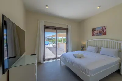 a bedroom with a bed and a sliding glass door at Joubal Lagoon II 4-Bedroom Villa with Private Pool & Lagoon Views in Hurghada