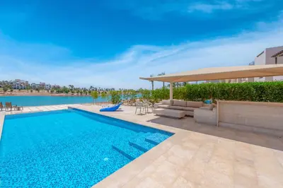 a swimming pool on the side of a building at Joubal Lagoon II 4-Bedroom Villa with Private Pool & Lagoon Views in Hurghada