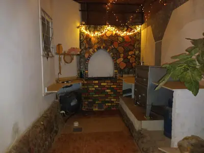 a kitchen with a stone wall with a stove at Rum i villa med pool in Hurghada