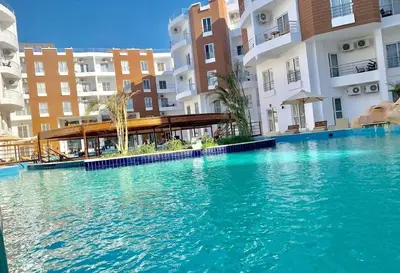 a large swimming pool in front of some buildings at Aqua Palms resort -Lovely studio in Hurghada