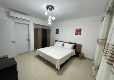 a bedroom with a white bed and a window at G-Cribs 2 Bed Rooms in Hurghada
