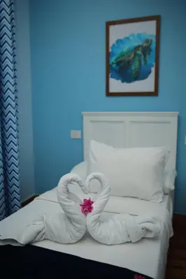 a bed with two towels in the shape of a heart at Tiba Rose hurghada in Hurghada