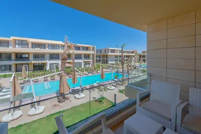 a view of the pool from the balcony of a resort at Boho-Chic Studio Apartment in G-Cribs, Pool View in Hurghada