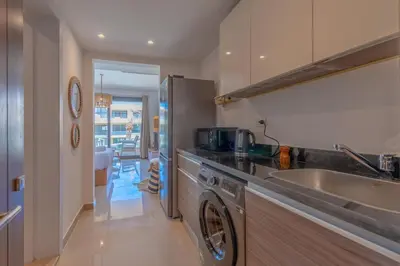 a kitchen with a washing machine and a sink at Boho-Chic Studio Apartment in G-Cribs, Pool View in Hurghada