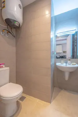 a bathroom with a toilet and a sink at Boho-Chic Studio Apartment in G-Cribs, Pool View in Hurghada