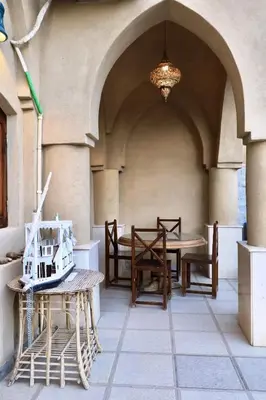 a patio with a table and chairs in a building at Villa Nur in Luxor