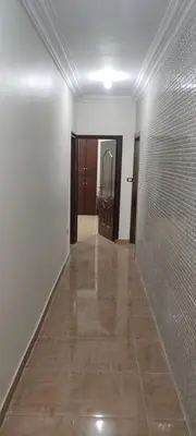 an empty hallway with a door and a tile floor at Luxor in Luxor