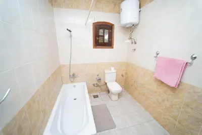 a bathroom with a tub and a toilet and a sink at Flower of Desert in Luxor