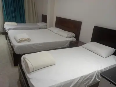 a group of three beds in a room at Le Mirage bay resort and aqua park one bedroom private studio inside view aqua building in Hurghada