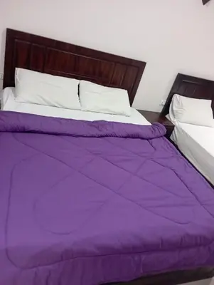 a purple comforter on a bed in a bedroom at Le Mirage bay resort and aqua park one bedroom private studio inside view aqua building in Hurghada