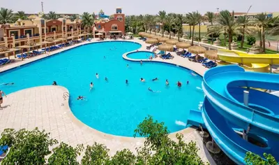 a large pool at a resort with people in it at Le Mirage bay resort and aqua park one bedroom private studio inside view aqua building in Hurghada