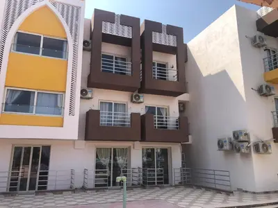 a building with balconies on the side of it at Le Mirage bay resort and aqua park one bedroom private studio inside view aqua building in Hurghada