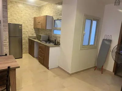 a kitchen with a refrigerator and a counter top at MARINA SKY in Hurghada
