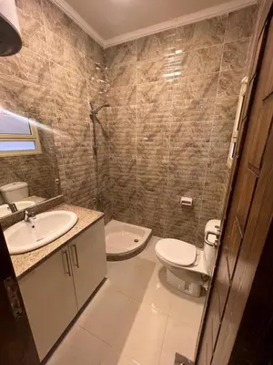 a bathroom with two sinks and a toilet in it at MARINA SKY in Hurghada