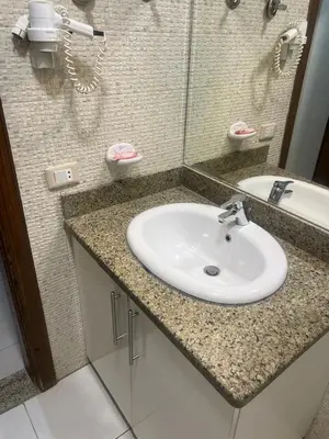 a bathroom counter with a sink and a mirror at MARINA SKY in Hurghada