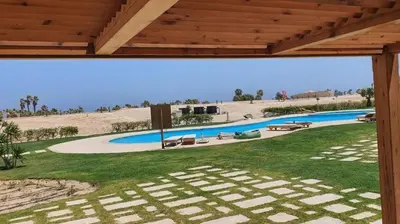 a view of a swimming pool from a house at Soma Bay Ambiance - Relaxed Apartment - Next to The Breakers in Hurghada
