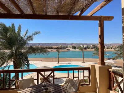 a view from the balcony of a resort with a swimming pool at Sabina 1br apartment Lagoon view with shared pool By BFG Beit Fel Gouna in Hurghada