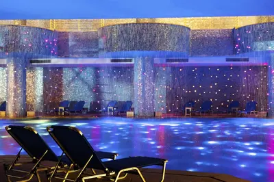 two chairs in front of a stage with lights at Pickalbatros Blu Spa Resort - Adults Friendly 16 Years Plus- Ultra All-Inclusive in Hurghada