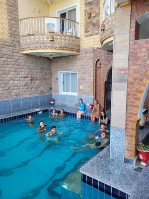 a group of people in a swimming pool at Blue Nile House in Luxor