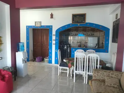 a kitchen with a table and chairs in a room at Nukud guest house in Aswan