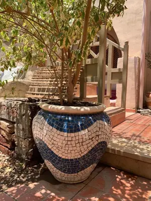 a pot with a tree in it sitting on a porch at The Residence in Luxor