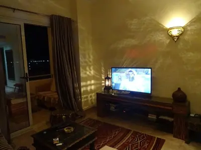 a living room with a flat screen tv on a table at Florenza - sea view in Hurghada
