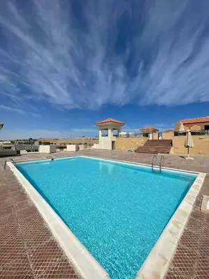 a large blue swimming pool on top of a building at Apartman Andalusie in Hurghada