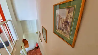 a hallway with a painting on the wall and a staircase at Prime Home The View Hurghada in Hurghada