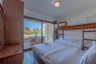 two bunk beds in a room with a view of the beach at Cozy 2-Bedroom Apartment in G-Cribs, El Gouna. Terrace & Pool in Hurghada