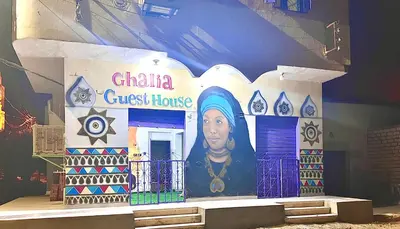 a building with a china guest house with a picture on it at Ghalia Guest House in Aswan