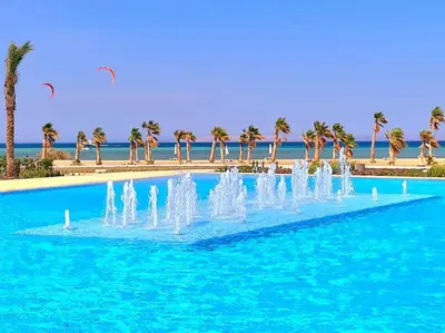 a fountain in the middle of a pool with palm trees at Luxurious Sea view 2 BR & private Garden to the pool at Mangroovy in Hurghada