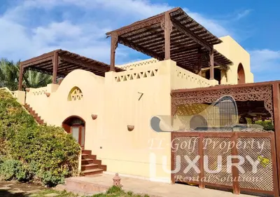 a building with a clock on the side of it at Villa 4 Bed Rooms-North Golf-GN24 in Hurghada