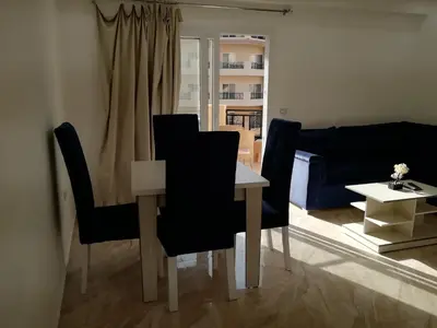 a living room with a table and chairs and a couch at Selena Bay Resort luxury 1 bedroom Apartments in Hurghada