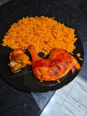 a plate with a chicken and rice on a table at Selena Bay Resort luxury 1 bedroom Apartments in Hurghada
