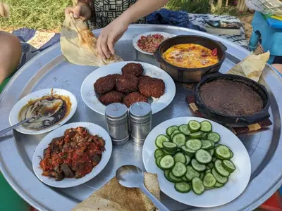 a table with plates of food on top at بيت شمس in Aswan