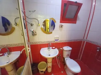 a bathroom with a toilet and a sink at Sabrina home in Aswan