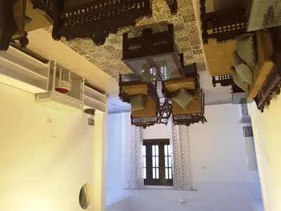a room with several lights on the ceilings at Family House in Luxor