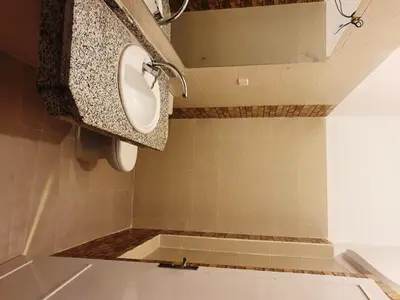 a bathroom with a sink and a toilet at Family House in Luxor