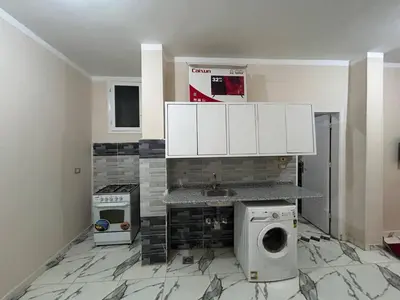 a kitchen with a sink and a washing machine at Egypt sun accommodation Spiritualities in Luxor