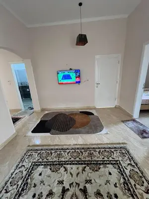 a living room with a tv on the wall at Egypt sun accommodation Spiritualities in Luxor
