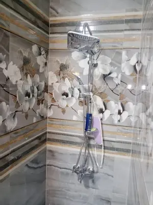 a room with a hair dryer and flowers on a wall at Outstanding Apartment with Marina Hurghada view in Hurghada