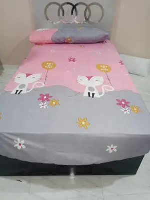 a bed with a pink blanket with flowers on it at Outstanding Apartment with Marina Hurghada view in Hurghada